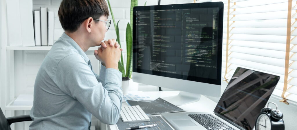 Male programmer is programing to developing program app and website of corporate while working