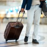 Luggage, airport and black man travel for business opportunity, international career and immigratio